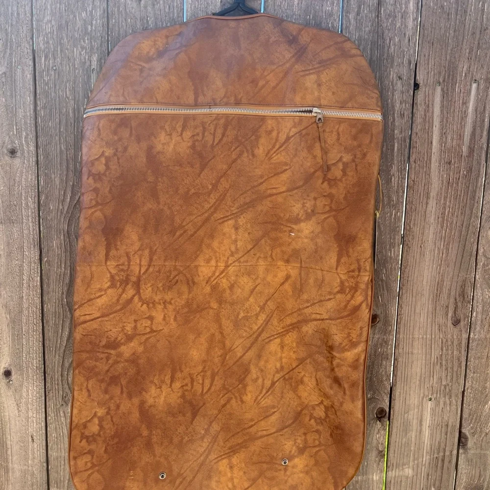 Vintage leather carry on for hanging clothes.